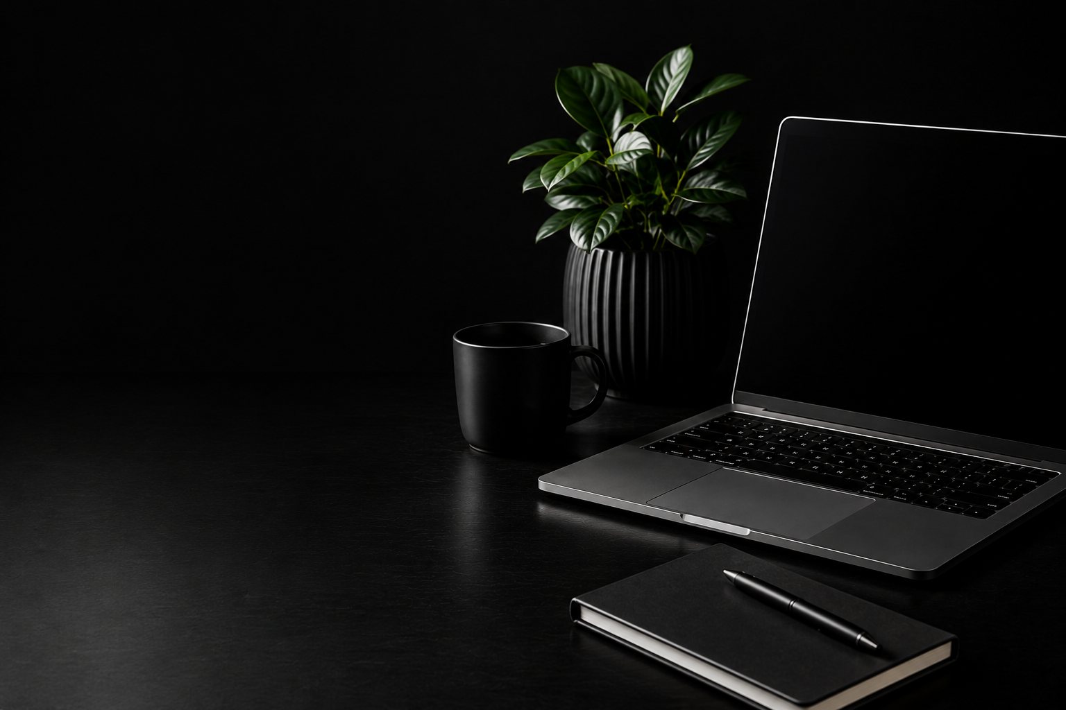 Laptop displaying Work Smarter Not Harder on a dark desk